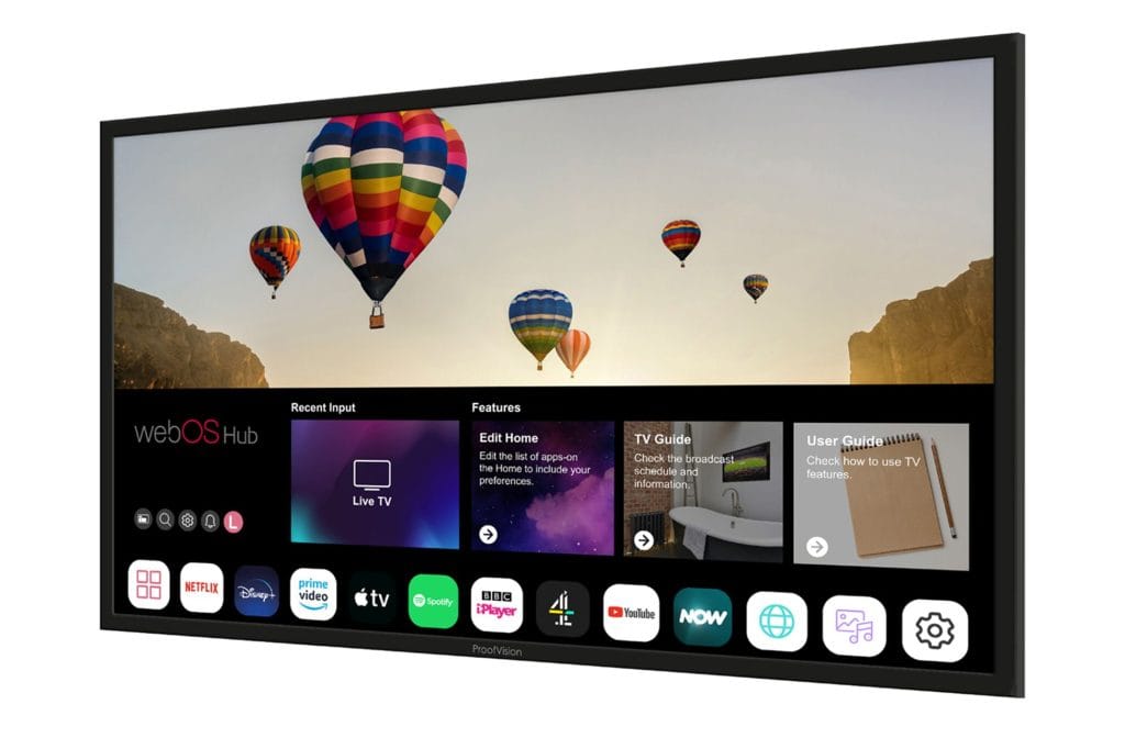 Proofvision - A smart TV screen displaying multiple colorful hot air balloons floating in the sky. Below the balloons, the TV menu interface shows various apps including Netflix, Apple TV, Disney+, YouTube, and others, with the options for "Live TV," "TV Guide," and "User Guide" visible.